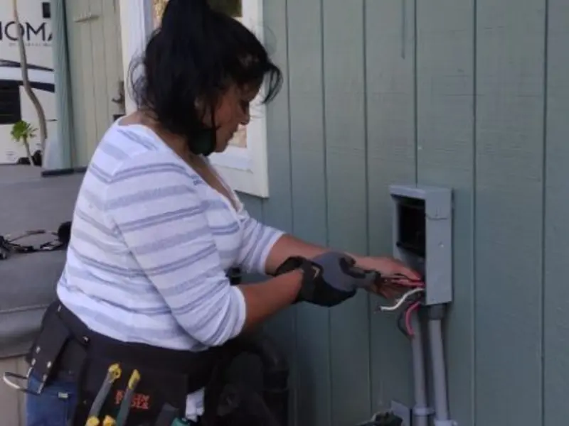 Licensed electrician wiring an exterior subpanel in Texas City